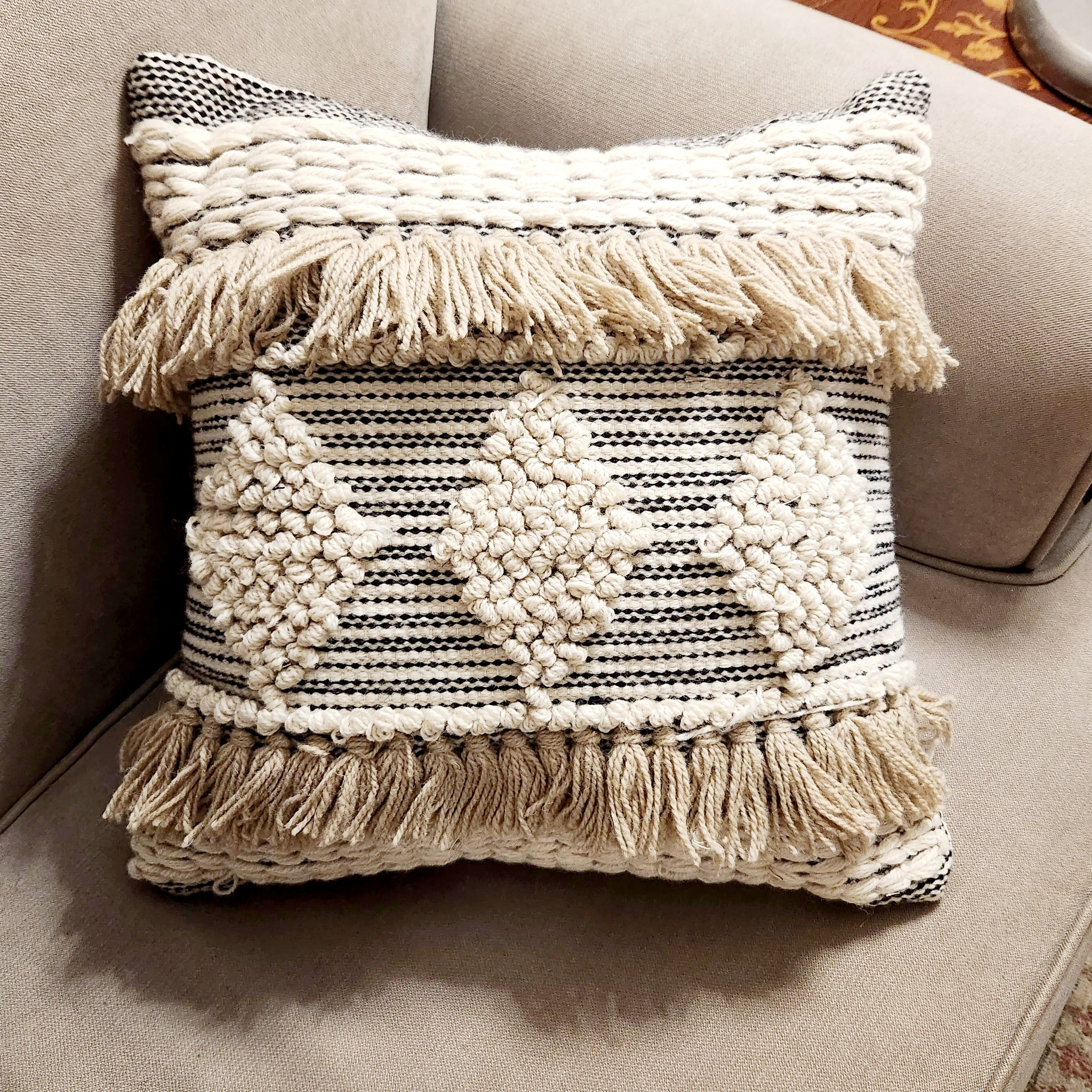 Decorative pillow with fringe on a couch