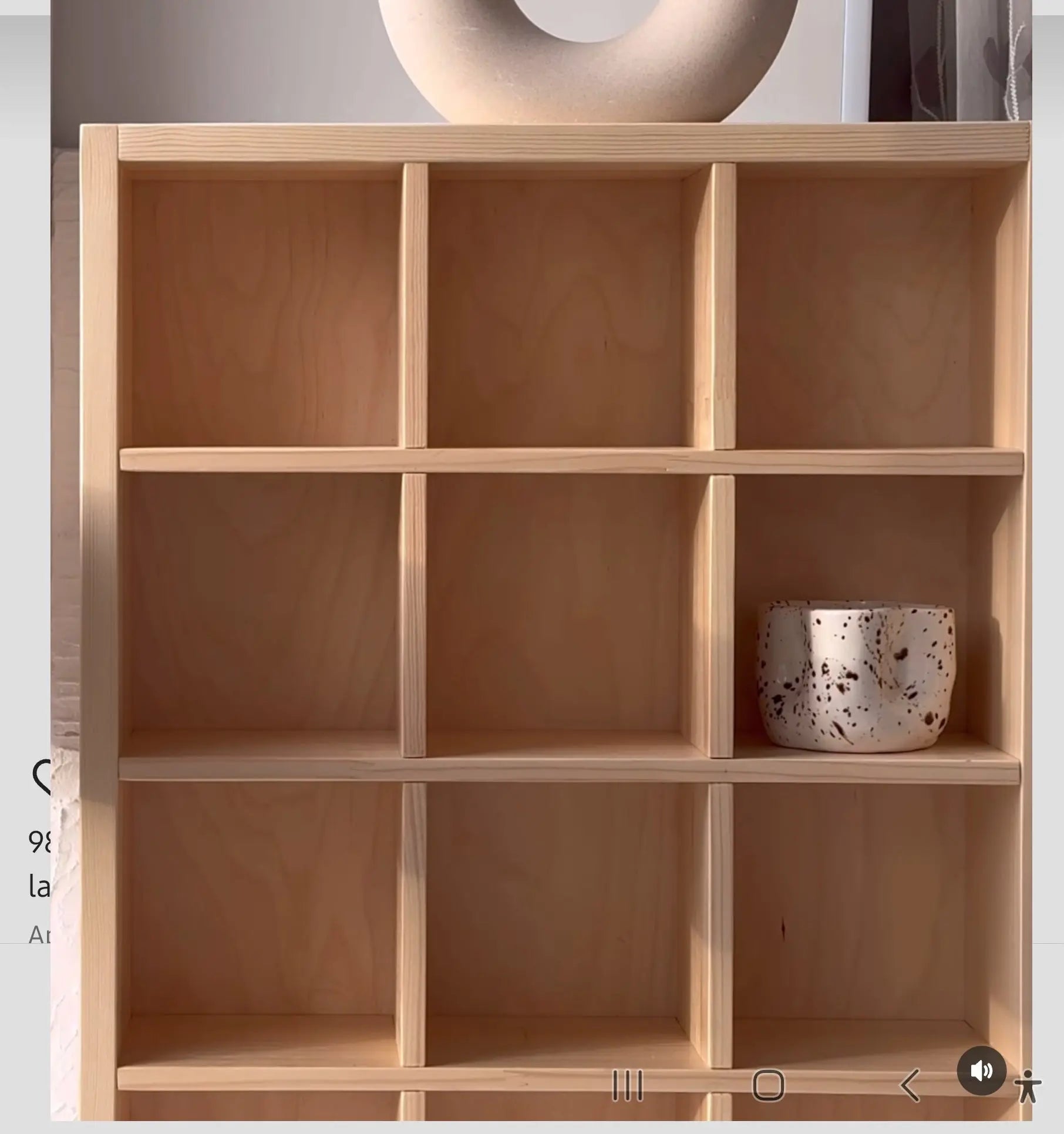 Wooden shelf with a decorative pot on a neutral background
