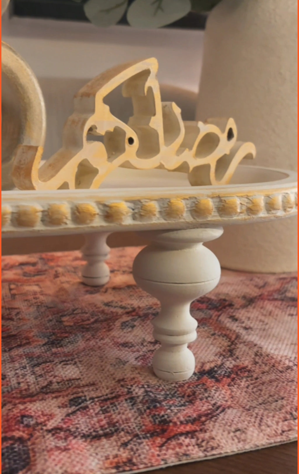 Decorative cake stand with intricate design on a patterned surface