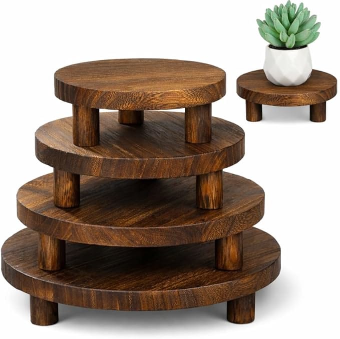Wooden tiered table with a small potted plant on a white background